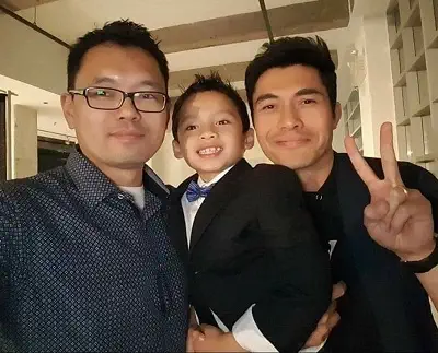 Actor Ian Ho with his father Eric Ho and actor Henry Golding