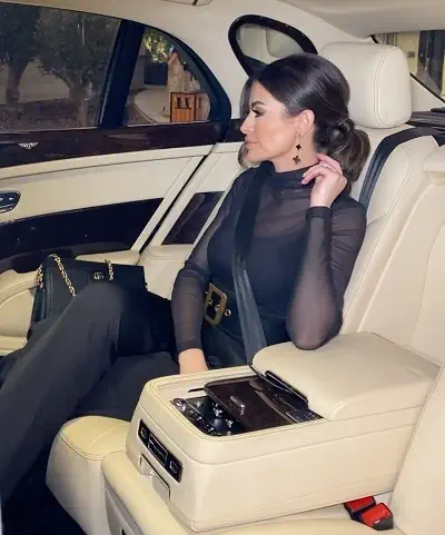 Nina Ali sitting in her expensive Bentley Flying Spur