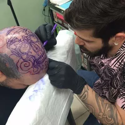 Gian Karle making a tattoo on head
