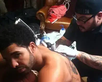 Nikko Hurtado Making Tattoo on Drake back