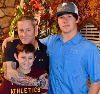 Tyler Doyle with his father and brother