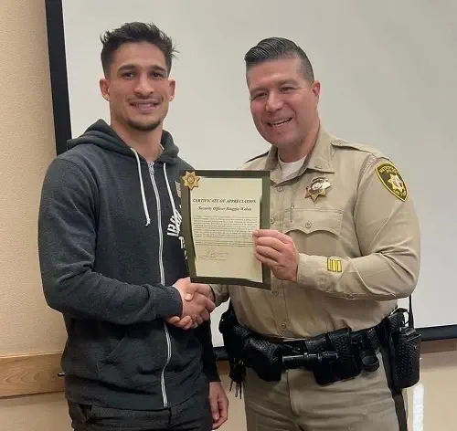 Biaggio Ali Walsh receiving certificate of appreciation from Police