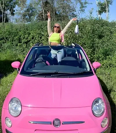 Molly Marsh in her Pink Fiat Car