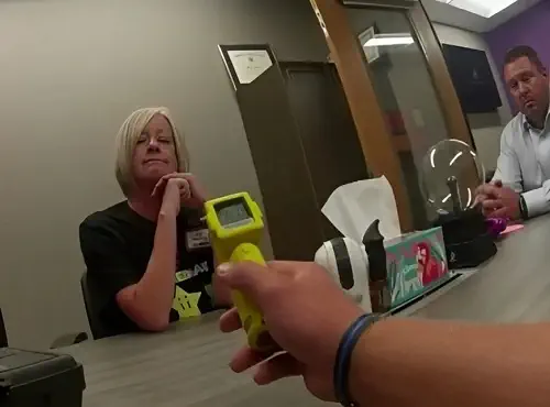 Kimberly Coates being checked by Alcohol Breath Analyzer